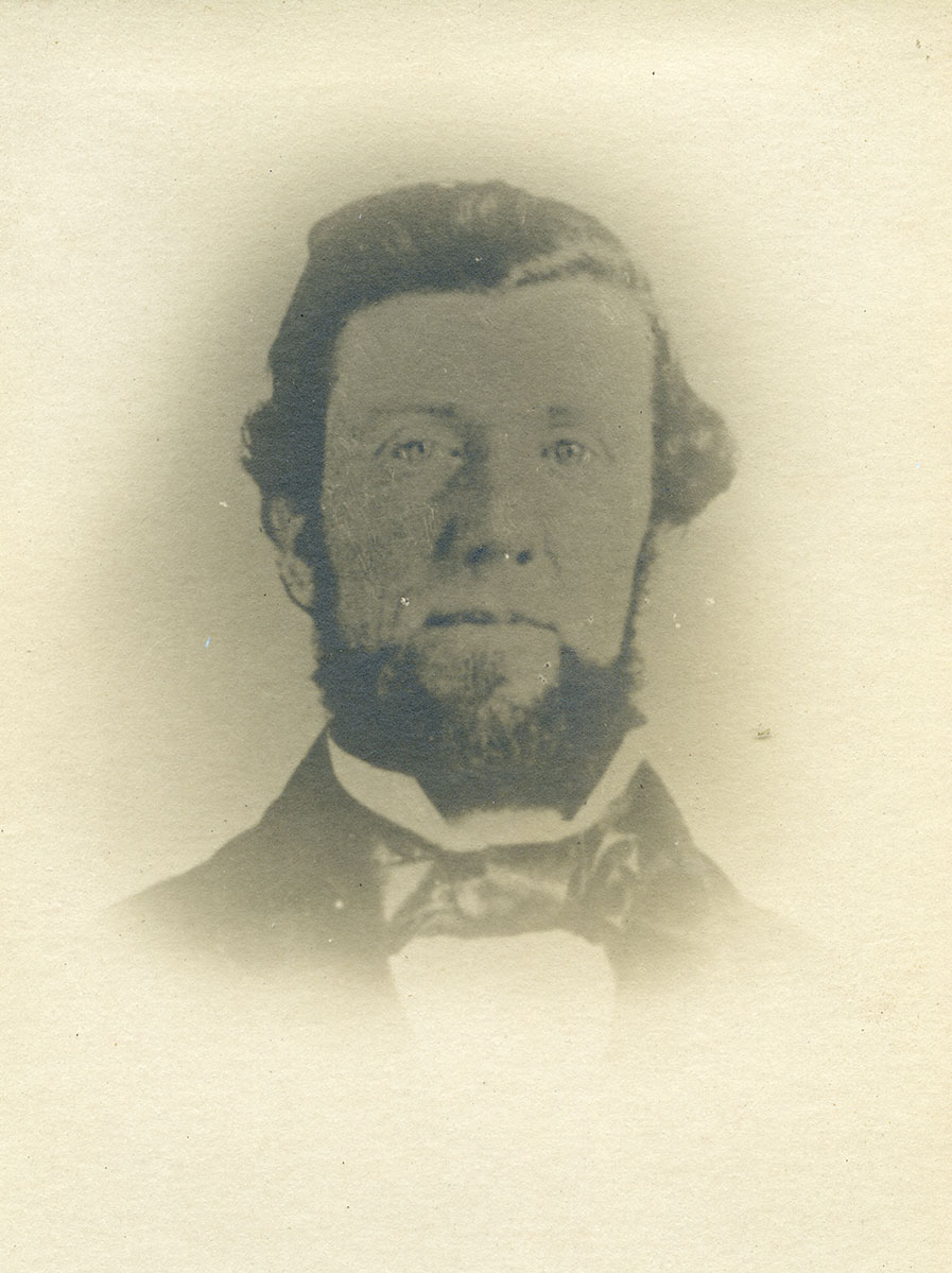 Historic image of an adult white male from the 1800s wearing a formal jacket and shirt.