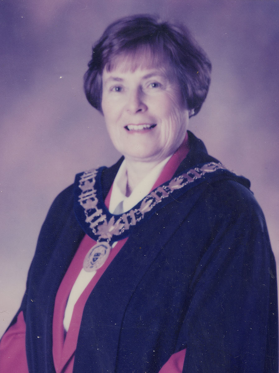 Photo of woman in a suit and warden medal.