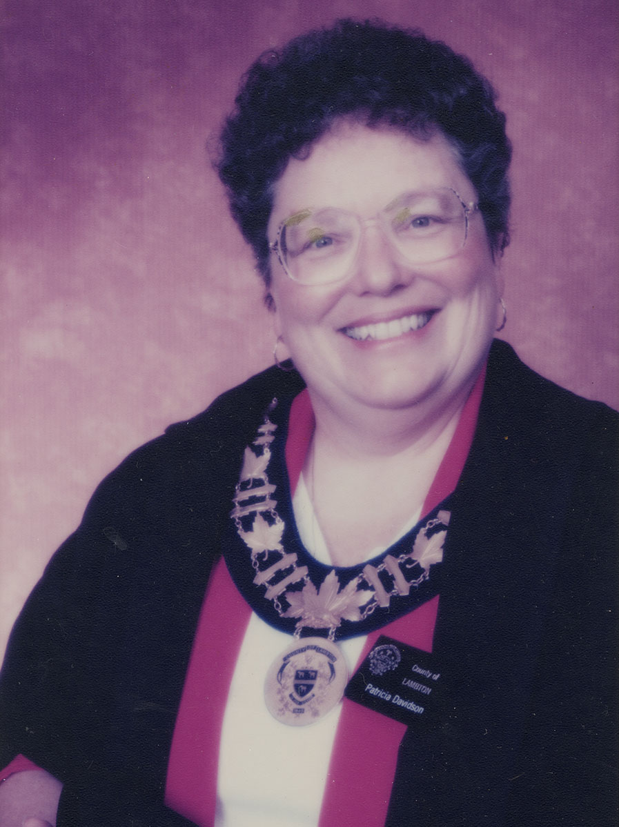 Photo of woman in a suit and warden medal.