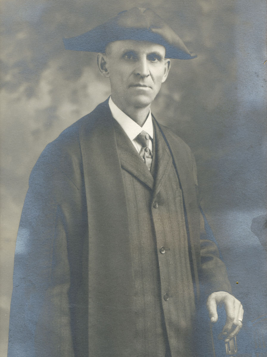 Historic image of an adult white male from the early 1900s wearing a formal jacket and shirt.