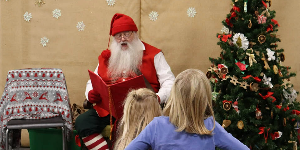 Children listen to holiday stories from Victorian Santa at the Oil Museum in 2023