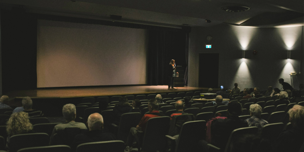 A person speaking on stage at Sarnia Library Theatre