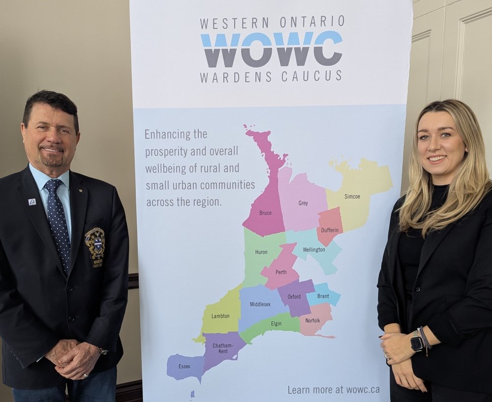 Warden Kevin Marriott and Mayor Amy Martin stand beside a WOWC banner showing the represented municipalities