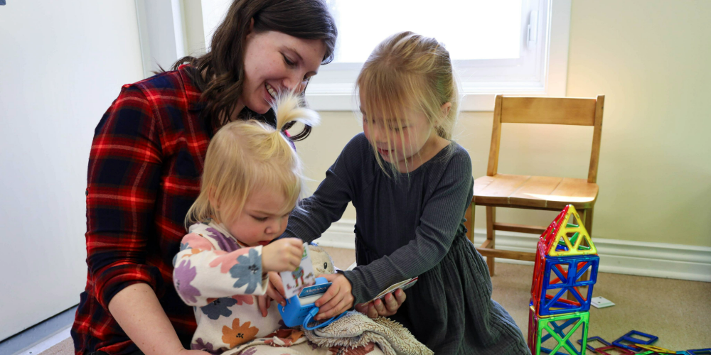 Vanessa Rapagna (Left) and Baker and Townes Crowley listen to stories on the new Yoto Player