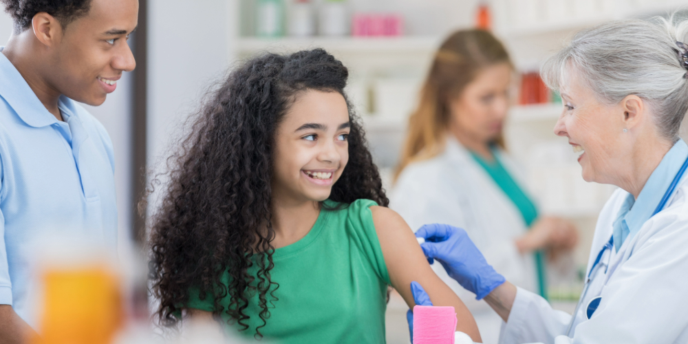 Young woman receives a vaccine from a pharmacist